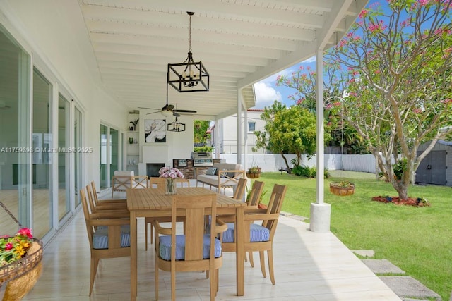 view of patio featuring fence, outdoor dining area, and a ceiling fan