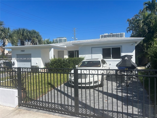 view of front of home featuring a fenced front yard, stucco siding, and a gate