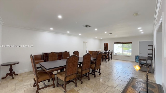 dining area with stone tile floors, baseboards, visible vents, and ornamental molding