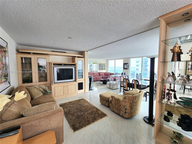 living area with tile patterned floors and a textured ceiling