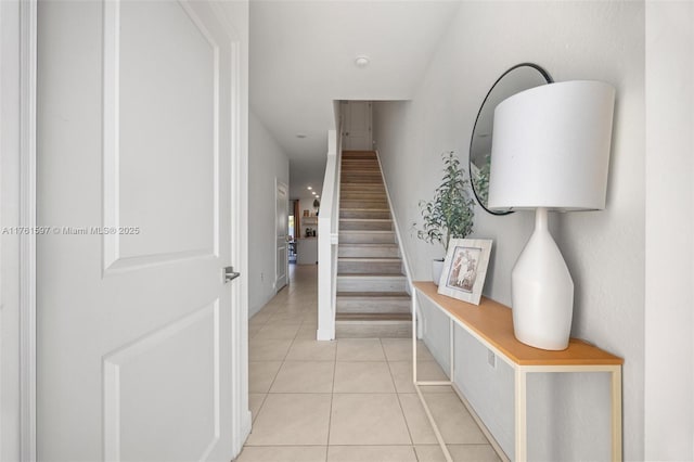 stairway with tile patterned floors