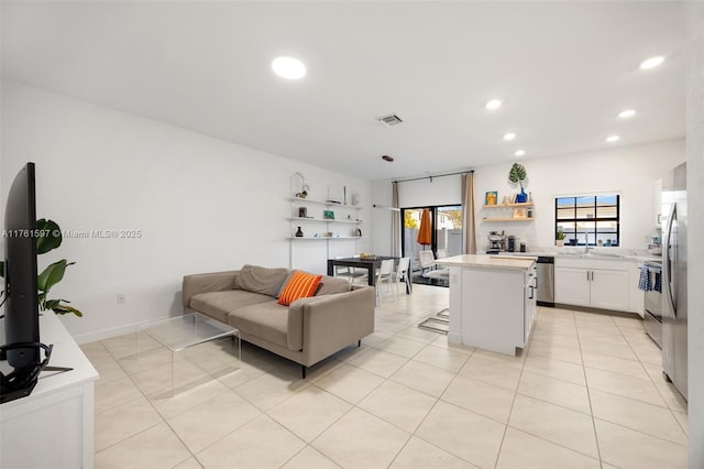 living room featuring light tile patterned flooring, visible vents, and recessed lighting