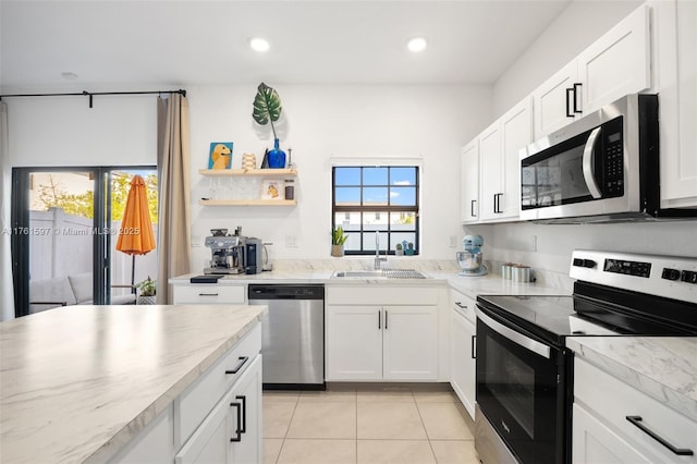 kitchen featuring a sink, light countertops, a healthy amount of sunlight, and stainless steel appliances