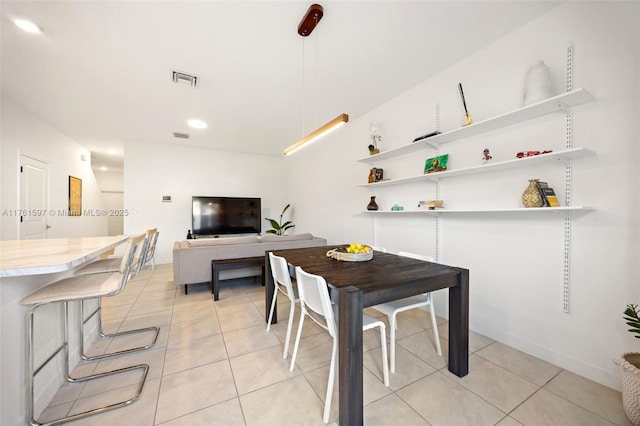 dining area with light tile patterned flooring and visible vents