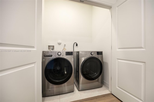 clothes washing area with laundry area and washer and clothes dryer