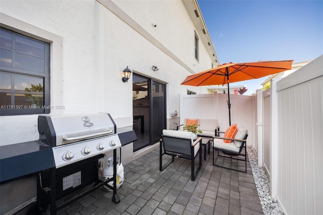 view of patio featuring fence and grilling area