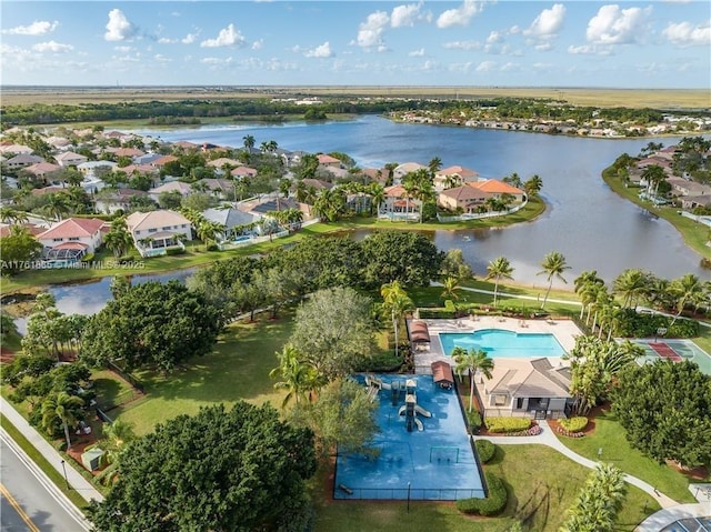 drone / aerial view featuring a residential view and a water view