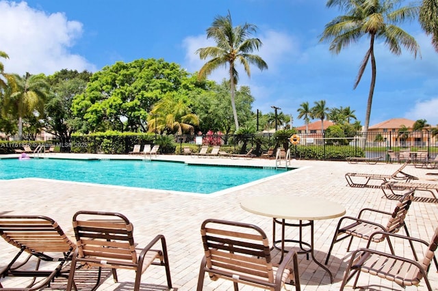 pool featuring a patio area and fence