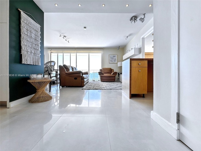 living area featuring light tile patterned flooring, track lighting, recessed lighting, and baseboards