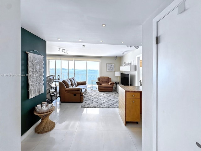 living area featuring light tile patterned floors and recessed lighting