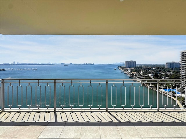 balcony featuring a view of city and a water view