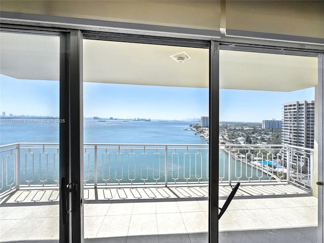 balcony featuring a city view and a water view