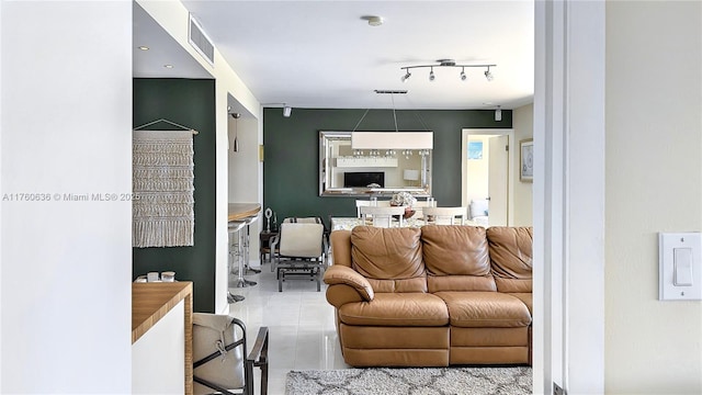 living room with tile patterned flooring, visible vents, and rail lighting