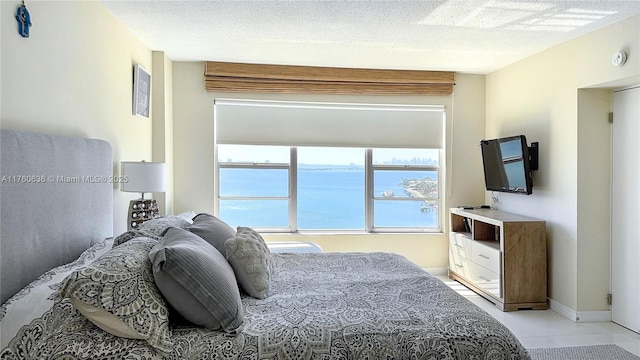 bedroom featuring baseboards and a textured ceiling