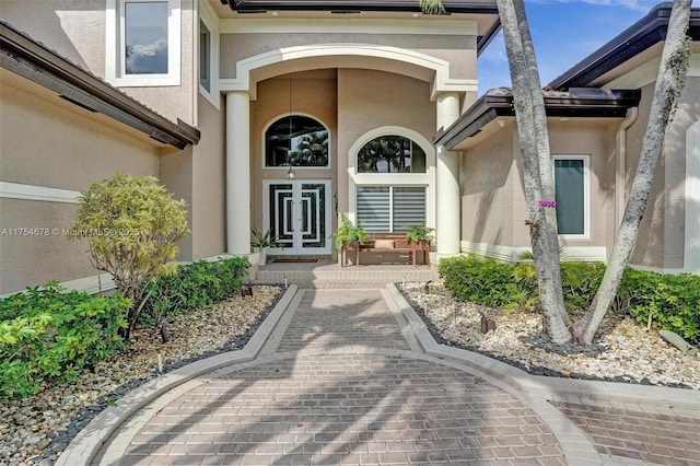 view of exterior entry featuring stucco siding