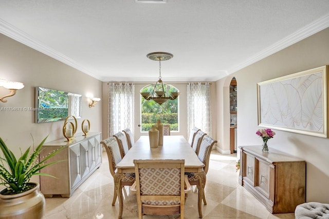 dining room with arched walkways and crown molding