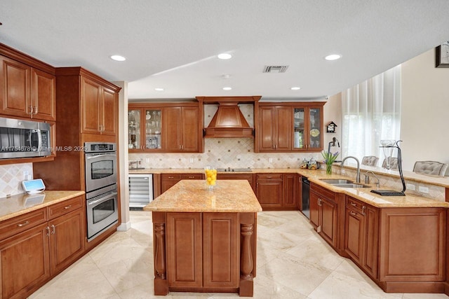 kitchen featuring visible vents, custom exhaust hood, a sink, black appliances, and wine cooler