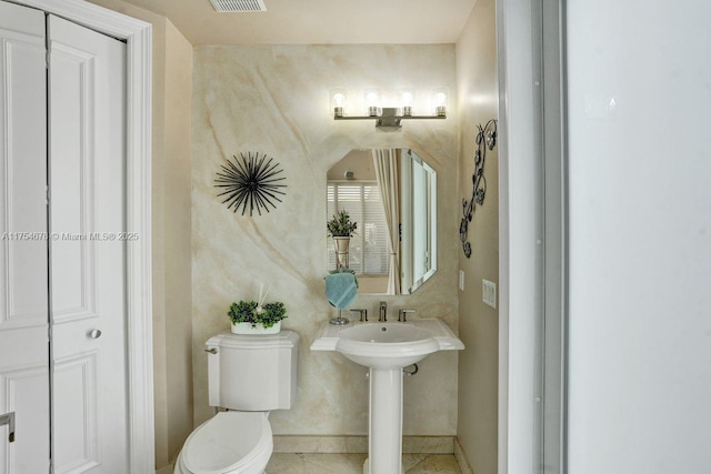 bathroom with baseboards, visible vents, a sink, tile patterned floors, and toilet