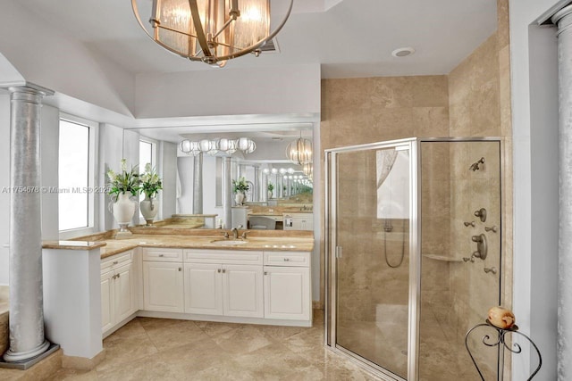 bathroom featuring a chandelier, a stall shower, vanity, and ornate columns