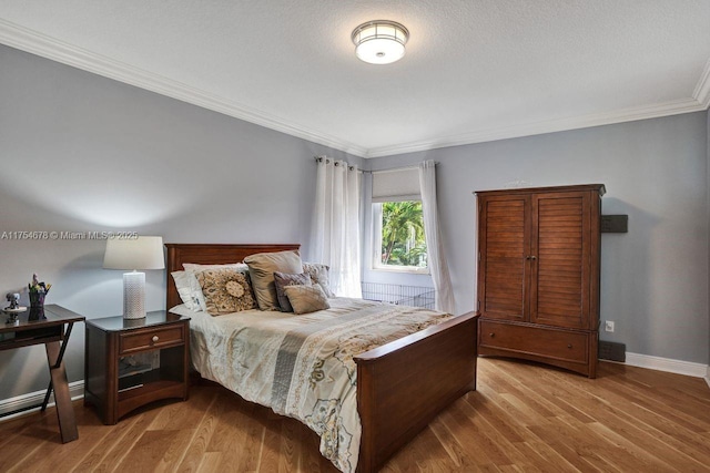 bedroom featuring baseboards, light wood-style flooring, and ornamental molding