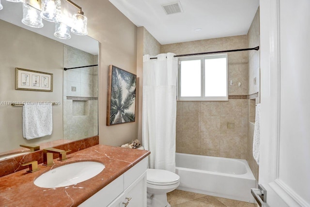 bathroom featuring vanity, visible vents, tile patterned flooring, shower / tub combo, and toilet