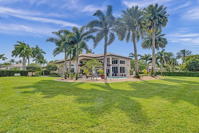 rear view of property featuring a yard