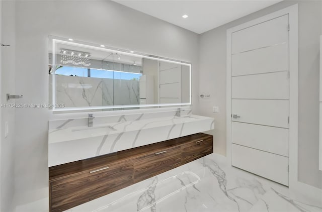 full bathroom with a marble finish shower, double vanity, recessed lighting, marble finish floor, and a sink