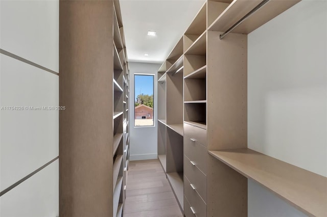 clothes washing area featuring light wood finished floors