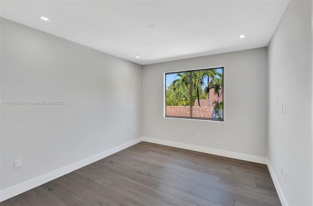 empty room with recessed lighting, baseboards, and wood finished floors