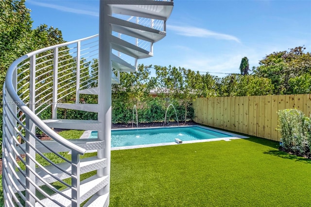 view of swimming pool featuring a yard, a fenced in pool, and a fenced backyard