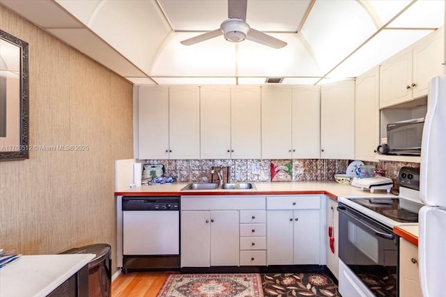 kitchen featuring white appliances, visible vents, ceiling fan, a sink, and light countertops