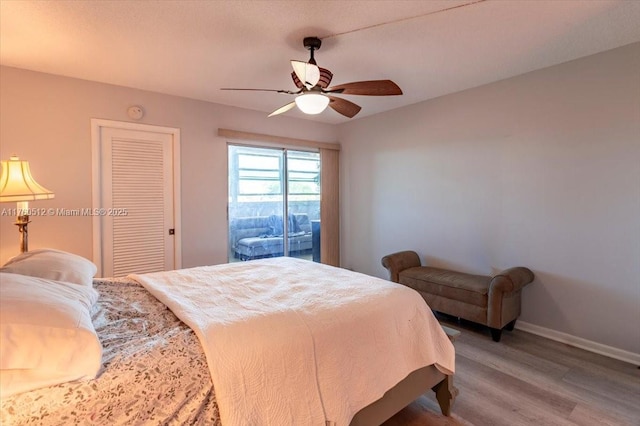 bedroom featuring baseboards, a ceiling fan, and light wood finished floors