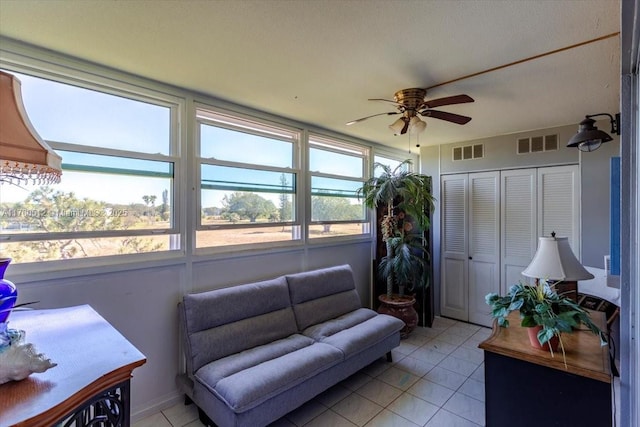 sunroom featuring visible vents and ceiling fan