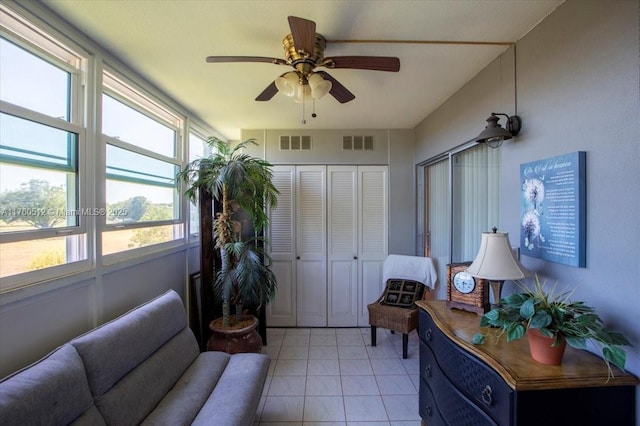 interior space featuring a ceiling fan and visible vents