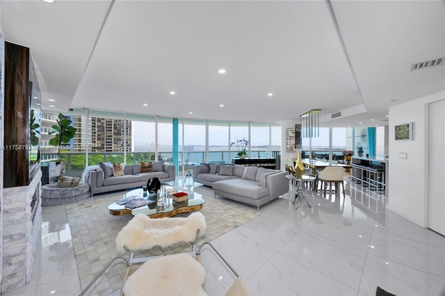 living area with recessed lighting, visible vents, floor to ceiling windows, and marble finish floor