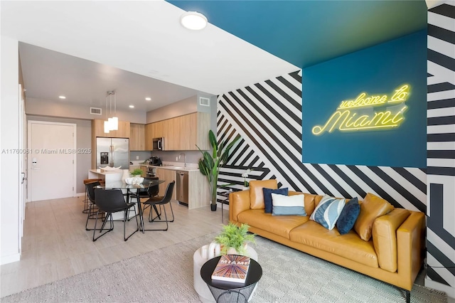 living room featuring recessed lighting and visible vents