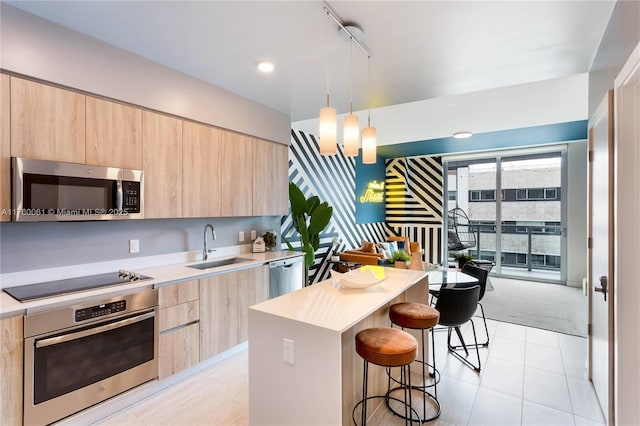 kitchen featuring a sink, stainless steel appliances, modern cabinets, and light brown cabinets