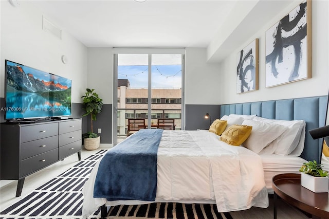 bedroom with floor to ceiling windows and access to outside