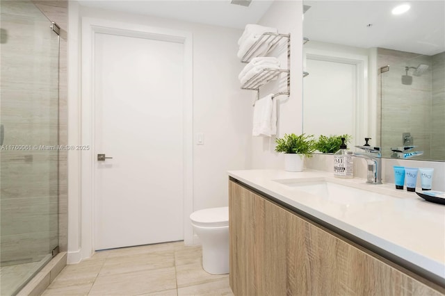 full bathroom featuring vanity, toilet, a shower stall, and tile patterned flooring