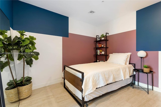 bedroom with visible vents and baseboards