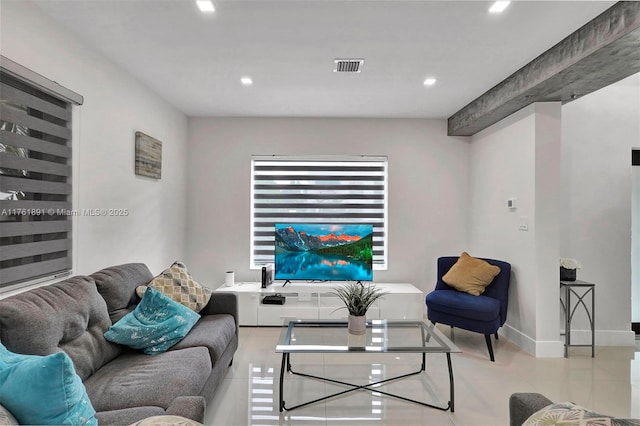 living area featuring tile patterned flooring, visible vents, recessed lighting, and baseboards