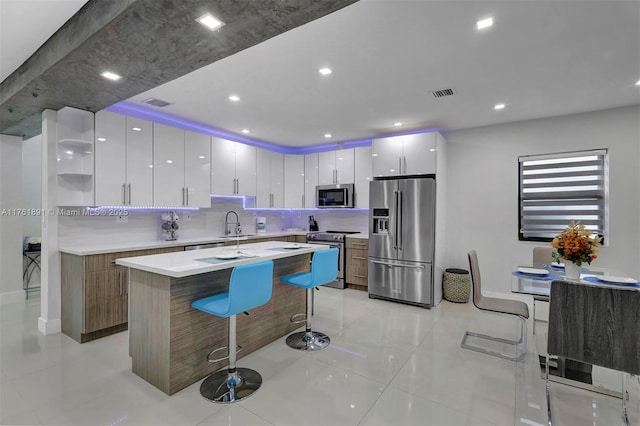 kitchen with open shelves, stainless steel appliances, visible vents, and modern cabinets