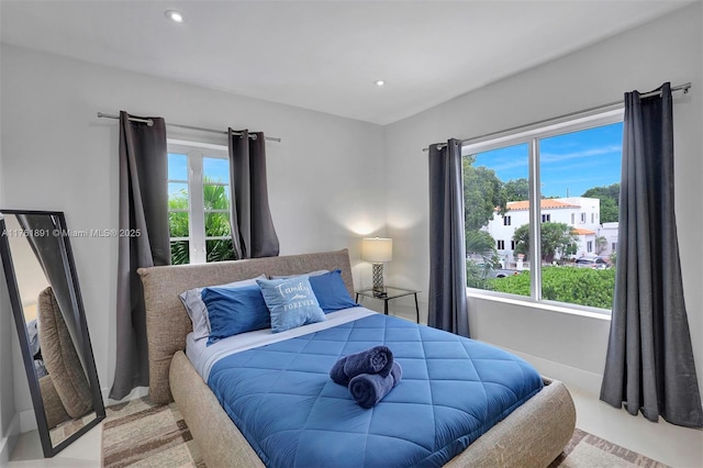 bedroom with recessed lighting, baseboards, and multiple windows