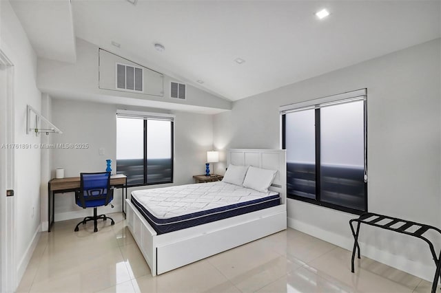 bedroom featuring visible vents, lofted ceiling, baseboards, and light tile patterned flooring