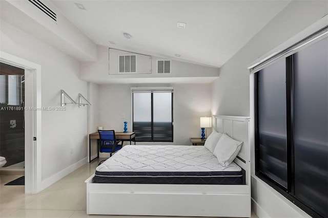 bedroom with vaulted ceiling, baseboards, and visible vents