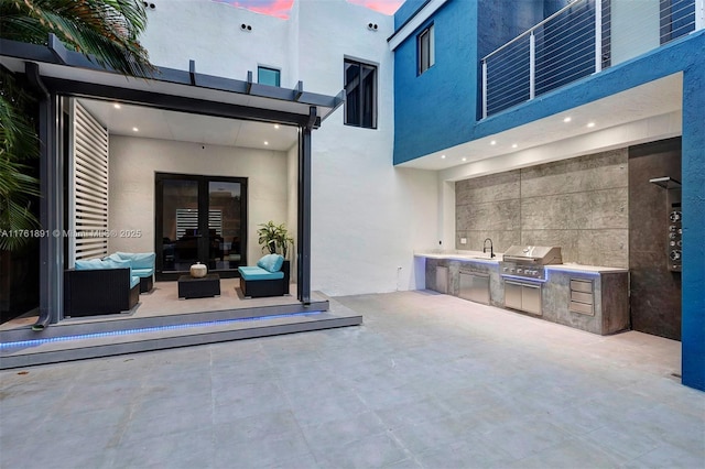 view of patio featuring an outdoor living space, area for grilling, and french doors