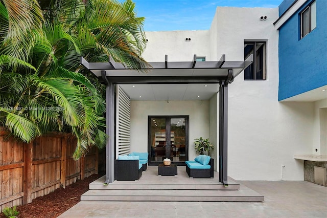 view of patio / terrace with french doors, a pergola, outdoor lounge area, and fence