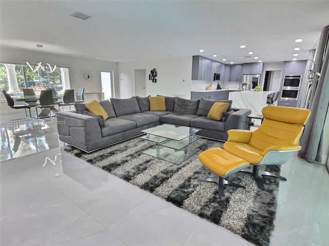 living room with recessed lighting and visible vents