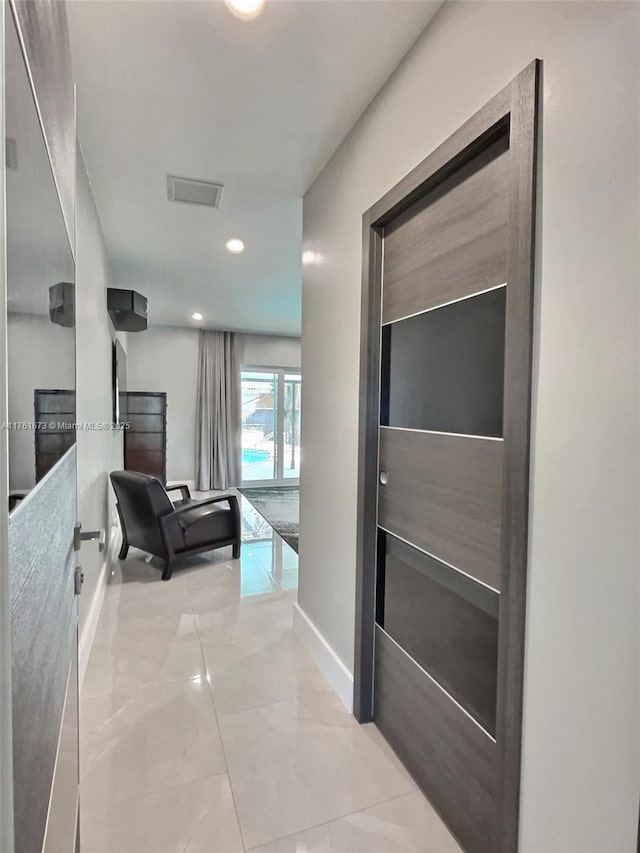 hallway featuring visible vents, recessed lighting, and baseboards