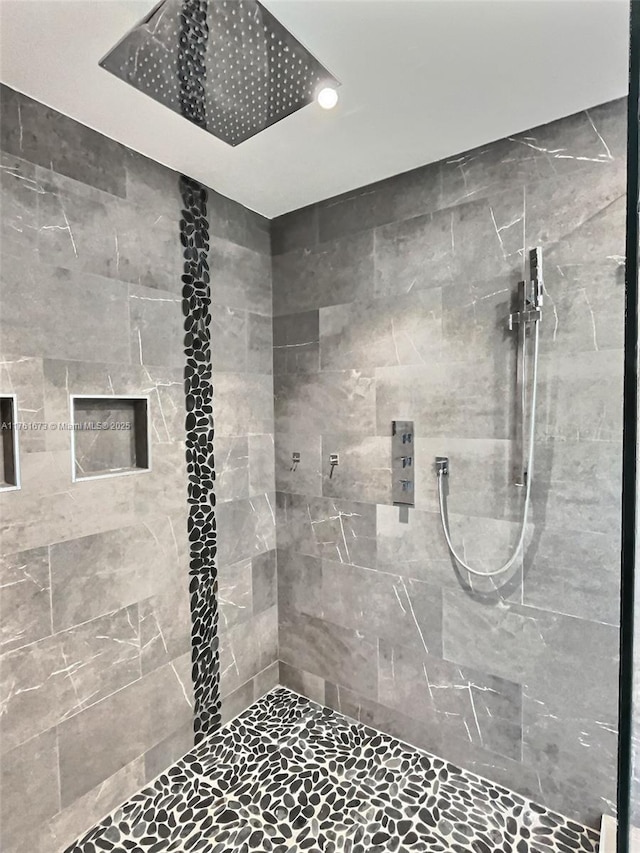 full bath with a tile shower